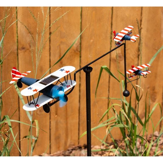 biplane balancer in front of fence biplane balancer in front of fence