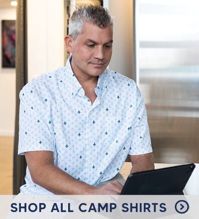 Guy wearing camp shirt on the beach